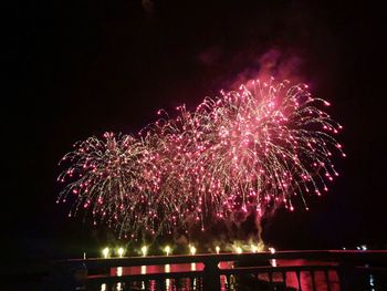 Low angle view of firework display at night