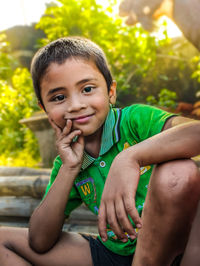 Portrait of village boy sitting outdoors