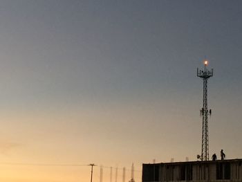 Low angle view of street light against sky at sunset