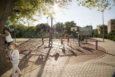 People playing on swing in park