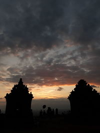 Silhouette buildings against sky during sunset