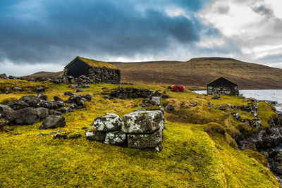 An old abandoned hamlet in the faroe islands. mountains and lake on background. high quality photo