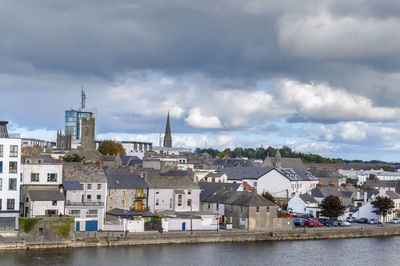 River amidst buildings against sky