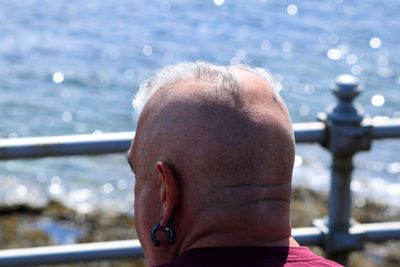 Close-up portrait of manlooking over water