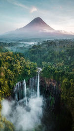 Scenic view of waterfall against sky