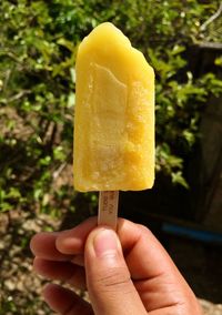 Close-up of hand holding ice cream cone