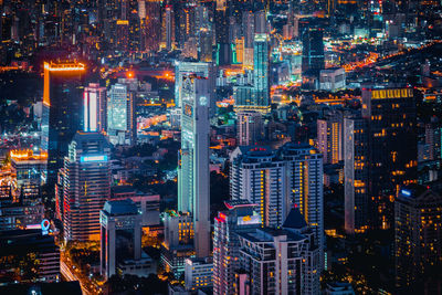 High angle view of city lit up at night