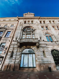 Low angle view of old building against blue sky