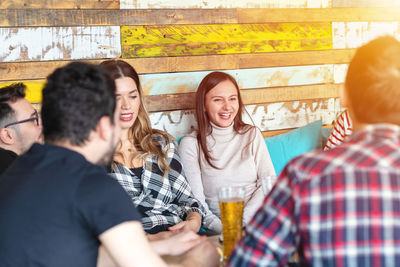 Group of people drinking glass against the wall