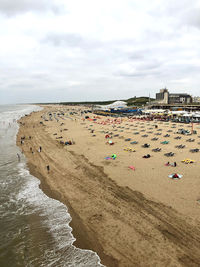 Group of people on beach against sky