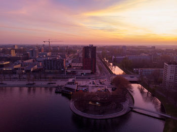High angle view of buildings in city during sunset