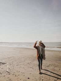 Full length of young woman walking at beach