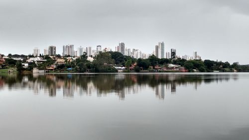 Reflection of buildings in lake against sky