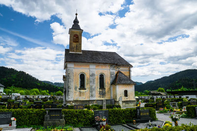 Church on landscape against clouds