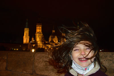 Portrait of smiling girl at night