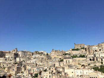 Buildings in city against blue sky