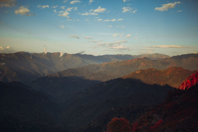 Scenic view of mountains against cloudy sky