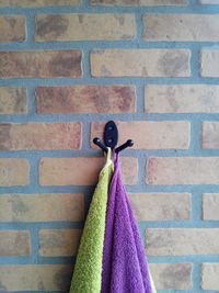 Close-up of towels hanging on hook mounted on wall