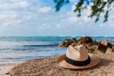 Straw hat in rum point beach overlooking the ocean
