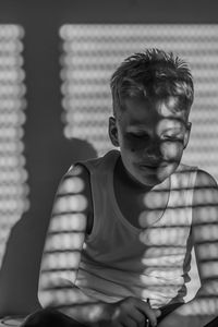 Portrait of boy sitting at home