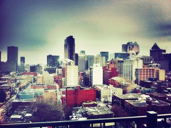 Cityscape against cloudy sky