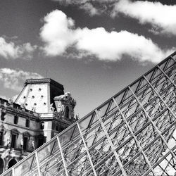 Low angle view of building against cloudy sky