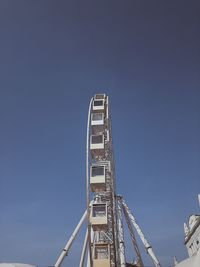 Low angle view of ferris wheel against clear sky