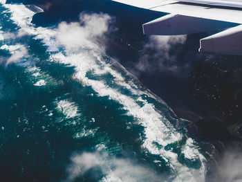 Aerial view of airplane wing over landscape