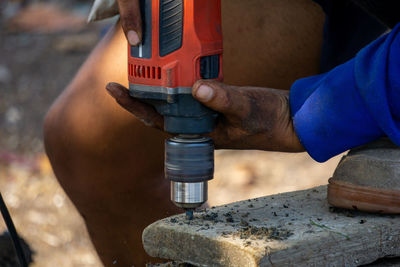 Close-up of man working on metal structure