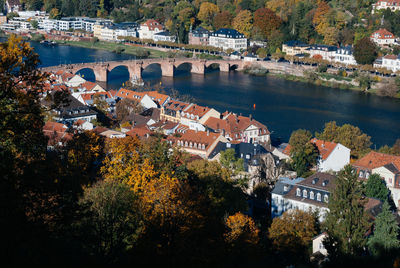 High angle view of townscape by river in city