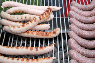 High angle view of sausages on barbeque grill