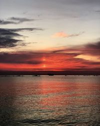 Scenic view of sea against romantic sky at sunset