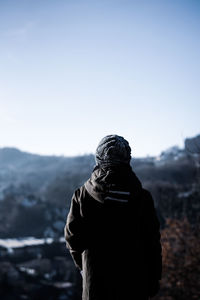 Rear view of statue against clear sky during winter