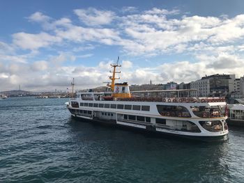 Ship in sea against sky in city