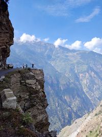 Tourists looking at view from a rocky mountain