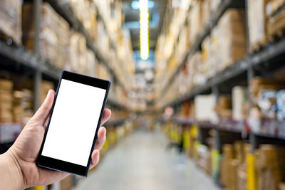 Low angle view of hand using mobile phone