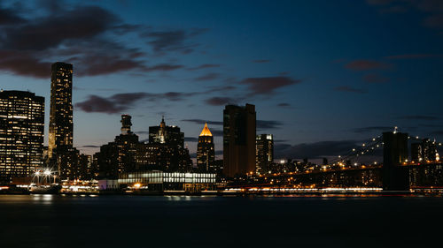 Illuminated buildings against sky at night