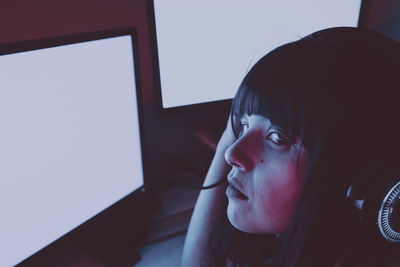 Portrait of teenage girl using mobile phone at home