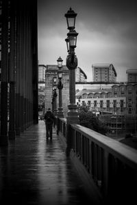 Rear view of man walking on street in city