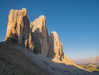 Rock formations on mountain against clear sky