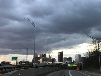 View of cityscape against cloudy sky