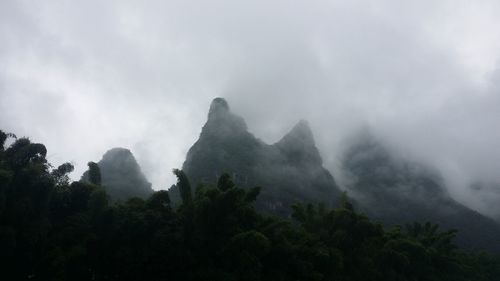 Scenic view of mountains against cloudy sky