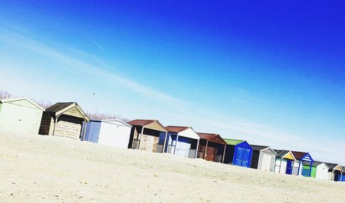 Low angle view of beach against clear blue sky