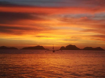 Scenic view of sea against orange sky