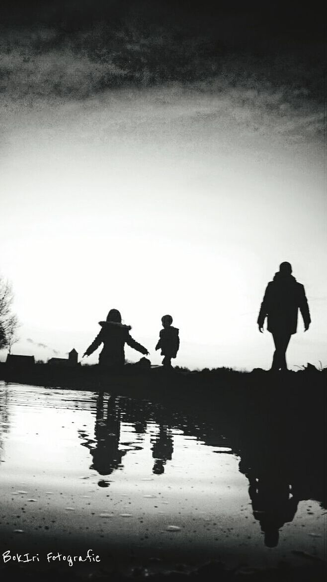 silhouette, water, men, lifestyles, leisure activity, togetherness, reflection, bonding, standing, person, full length, lake, sky, love, rear view, boys, nature