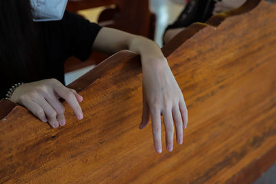 High angle view of woman hand on table