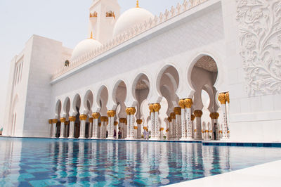 Low angle view of sheikh zayed mosque by pond