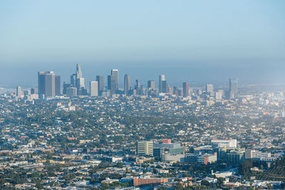 Aerial view of modern buildings in city against sky