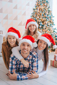 Portrait of happy family wearing santa hat