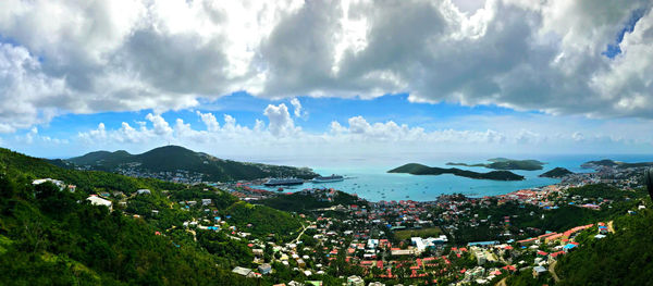 Panoramic view of town by sea against sky